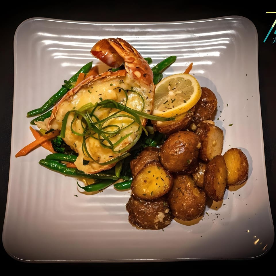 Truth Restaurant's Caribbean lobster tail with roasted potatoes, green beans, and a lemon slice.
